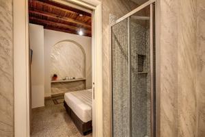 罗马Colosseo Accomodation Room Guest House的卧室设有玻璃门,可通往一张床