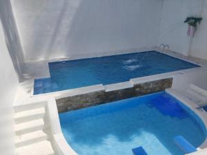 a large swimming pool with blue water at HIdeaway Euro Villa in Antipolo