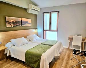 Postel nebo postele na pokoji v ubytování Hotel Olatu