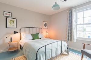a bedroom with a bed and a window at Seafarer by Keepers Cottages in Kingsdown