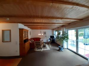 a living room with a wooden ceiling at Fewo Stricker 31 in Walkenried