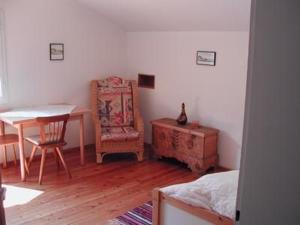 a bedroom with a table and a table and a chair at Gemütliches Ferienhaus In Lofer Mit Garten in Lofer +2 photos