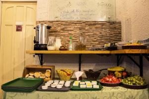 a table filled with different types of fruits and vegetables at Hostal Forestal in Santiago