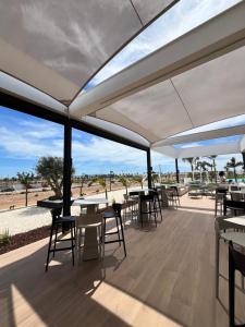 a patio with tables and chairs and a view of the desert at Santa Rosalía Lake and Life - INVBUILD ESTATES in Torre-Pacheco