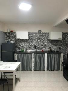 a kitchen with a counter in the middle of a room at Casa di Codo in Naples