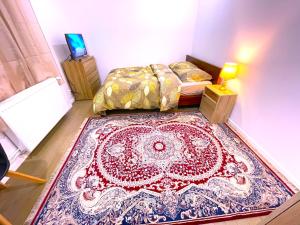 a bedroom with a bed and a rug on the floor at une chambre pas loin de paris et airport CDG in Bondy +5 photos
