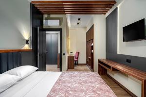 a bedroom with a bed and a flat screen tv at Sedir Park Joy Hotel in Seki