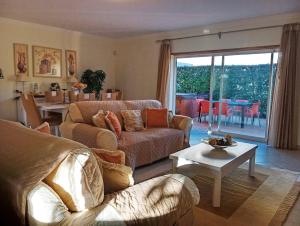 a living room with a couch and a table at Villa Oasis Parque BY SWEET HOME in Portimão