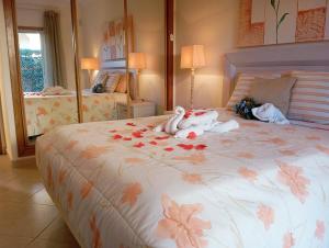 a bedroom with a large bed with flowers on it at Villa Oasis Parque BY SWEET HOME in Portimão +157 photos