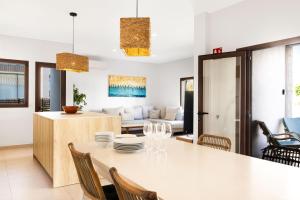 a dining room and living room with a table and chairs at Villa Can Ordinas in Alcudia