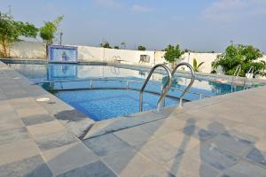 a small swimming pool with a metal rail in the middle at AS Garden Villa in Ranipet