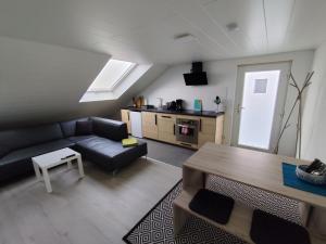 a living room with a couch and a table at Ferienwohnung Down Under am Bodensee in Uhldingen-Mühlhofen