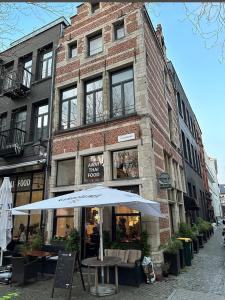 an umbrella in front of a brick building at Pleasant apartment ready for you to enjoy in Antwerp +16 photos