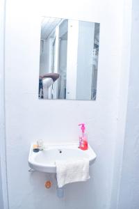 a bathroom sink with a mirror and a towel at Blessing homes in Mombasa