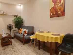 a waiting room with a table and a couch at AS Guest House in Libreville