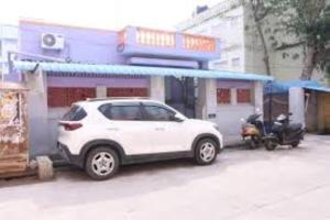 a white car parked in front of a gas station at Villa Saravana in Puducherry
