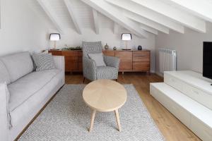 a living room with a couch and a table at H SUITE4A by Smiling Rentals in Hondarribia
