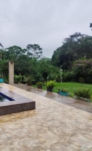 a rain soaked patio with a park in the background at Sítio Jacutinga 2025 in Pacoti