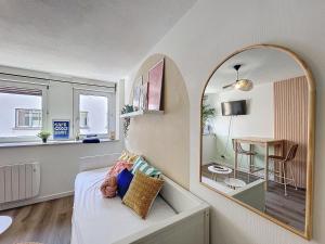 a bedroom with a mirror and a bed and a table at Le parthenon in Erstein