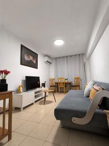 a living room with a bed and a dining room at The Sea Pearl Deganya 63 in Haifa