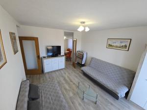 a living room with a couch and a tv at Apartman Valentic in Vinkovci