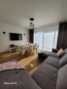 a living room with a couch and a table at Appartement à Sainte-Brieuc T3 CESSON in Saint-Brieuc