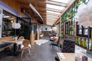 a restaurant with tables and chairs and windows at ALPENLIEBE - Sauna & Whirlpool - APARTments in Inzell
