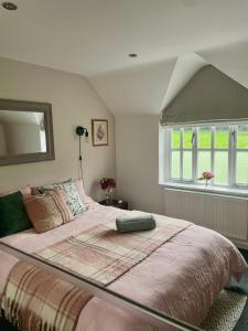 a bedroom with a large bed and a window at Cottage Guest House Nr Cheltenham on Cotswold Edge in Churchdown