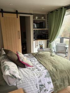 a bedroom with a bed with pillows and a window at Waters edge Pontypridd in Treforest