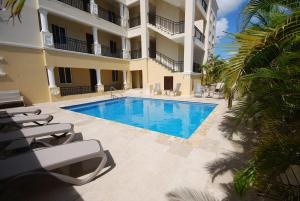 a swimming pool in front of a building at Hausmann Penthouse with Stunning Sea View in Kralendijk