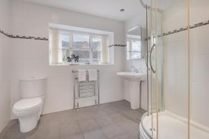 a bathroom with a toilet and a sink and a shower at Cozy Lake District House on the fells in Ambleside