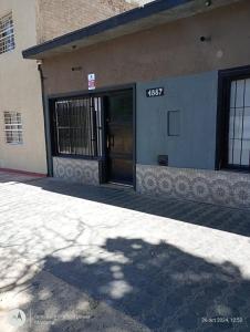 a building with a door with a clock on it at La Boca in Godoy Cruz