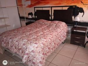 a bedroom with a bed and a table with two lamps at La Boca in Godoy Cruz