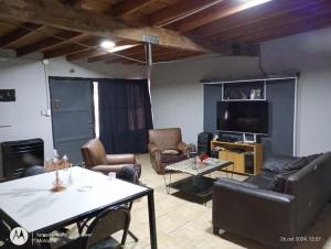 a living room with a couch and a table at La Boca in Godoy Cruz