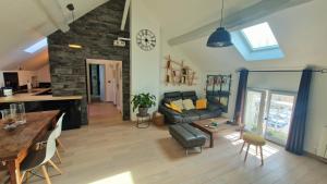 a living room with a couch and a table at L'atelier De Neuville in Neuville-sur-Oise