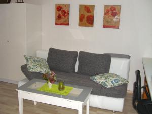 a living room with a couch and a table at Gemütliches Ferienhaus In Fischbach Rhön in Kaltennordheim