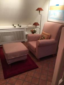 a living room with two chairs and a lamp at Ferienwohnung Biberhüs Obergeschoss In Archsum in Archsum