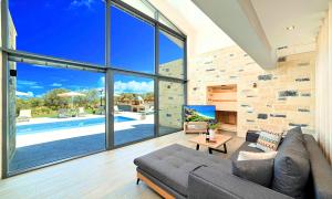 a living room with a couch and a large window at Ferienhaus Für 45 Personen In Chania, Kreta West Kreta in Georgioupolis