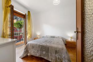 a bedroom with a bed and a large window at Casa Natalina in Recco
