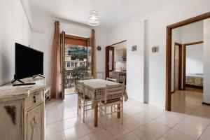 a living room with a table and a television at Casa Natalina in Recco