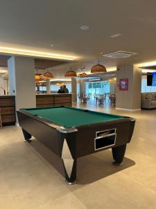 a pool table in the middle of a room at Hotel Don Juan Tossa in Tossa de Mar