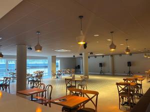 a dining room with tables and chairs and lights at Hotel Don Juan Tossa in Tossa de Mar