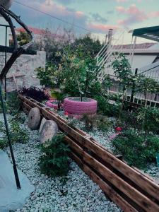 a garden with a wooden fence and some plants at Relatives Apartment in Mytilene