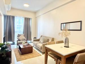 a living room with a couch and a table at Family-Friendly Condo Unit in Lapu Lapu City