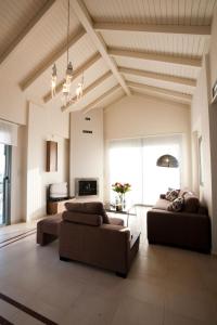 a large living room with two couches and a ceiling at Villa Pounentes in Kissamos +18 photos