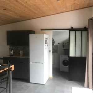 a kitchen with a white refrigerator in a room at L'Accugliente in Lecci