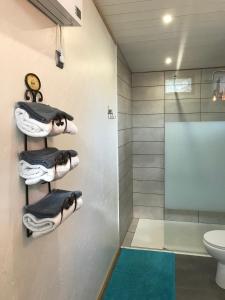 a bathroom with towels and a shower and a toilet at L'Accugliente in Lecci +53 photos