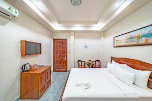 Una habitación de hotel con una cama y un televisor. en Venus Hotel, en Ho Chi Minh