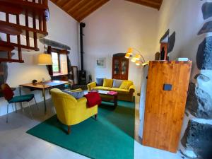 a living room with a yellow couch and a table at Quinta Perpetua, Casa Corvo in Alto do Sul