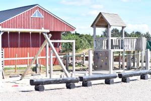 a playground with a slide and a climbing at Nymindegab Ridecenter Ferienwohnung in Nørre Nebel